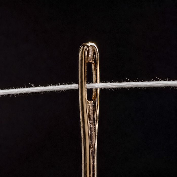 Thread passing through the eye of a needle